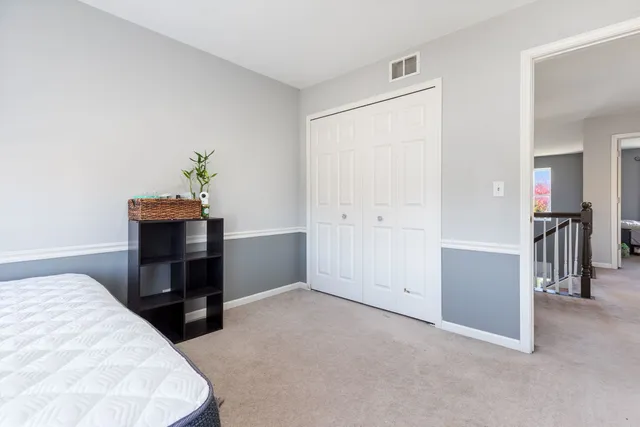 a bedroom with a bed and a desk