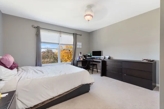 a bedroom with a bed and a mirror