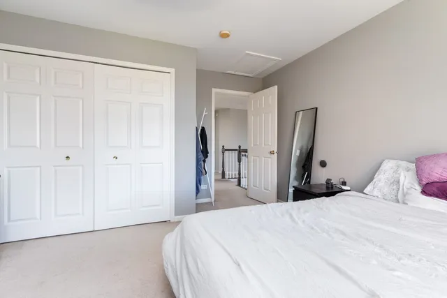 a bedroom with furniture and a clock