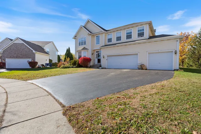 a view of a house with a yard and garage