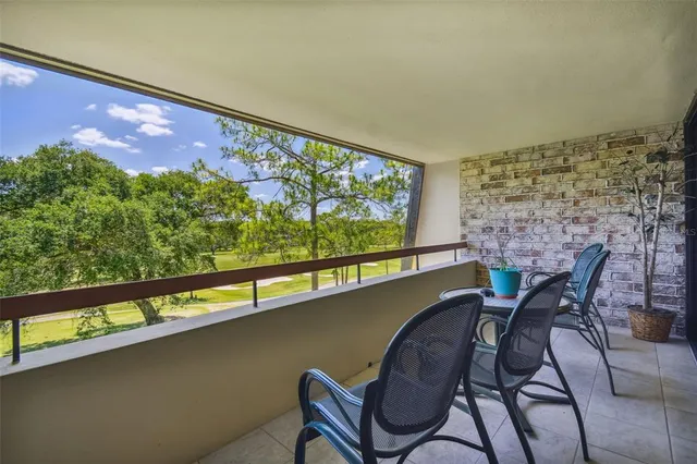 an aerial view of a house a yard and mountain view in back