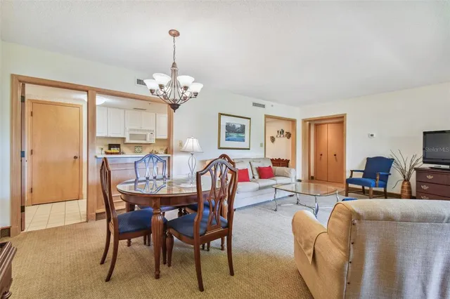 a view of a dining room with furniture and chandelier