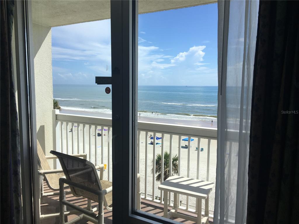 2700 North Atlantic Avenue, Unit 548 Daytona Beach, FL 32118 - Photo 4 of 6 a view of a room with a large window and chair