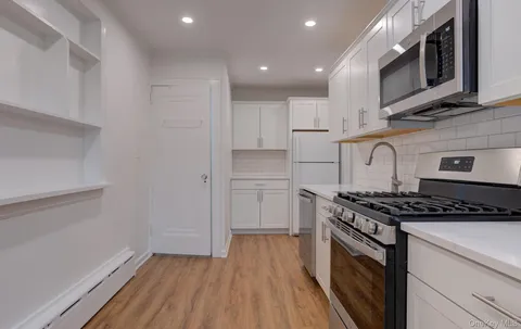a kitchen with granite countertop a stove and a sink