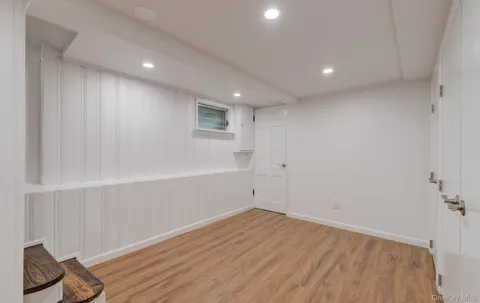 a view of room with wooden floor and fan