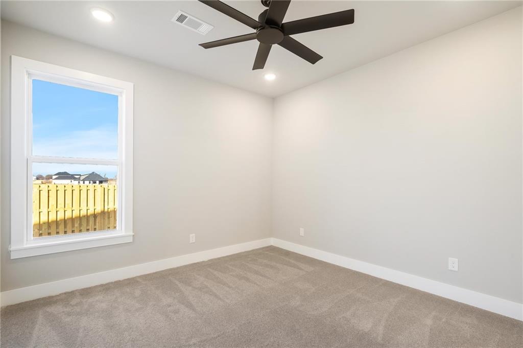 1910 Peacock Road Centerton, AR 72719 - Photo 19 of 29 Recessed ceiling lighting, ceiling fan, carpet flooring, single window, and a wood fence