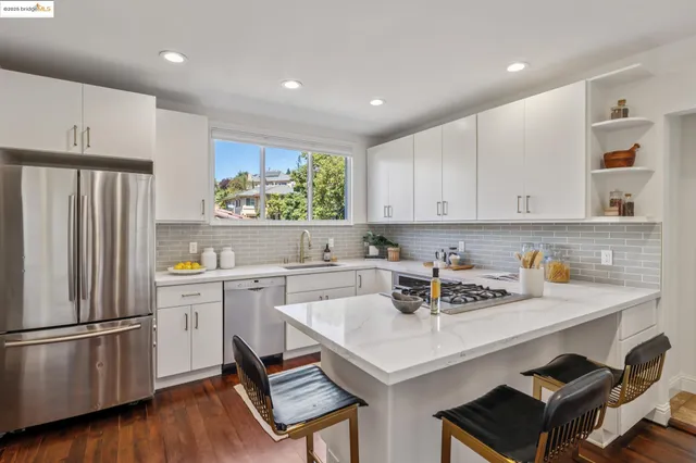 a kitchen with a sink stove top oven and cabinets