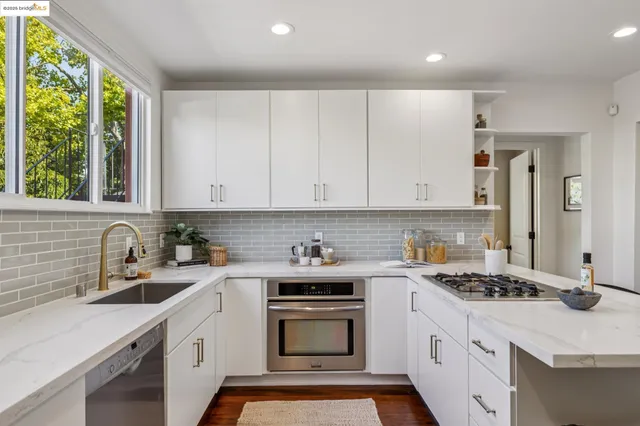 a kitchen with a stove sink and cabinets