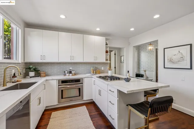 a kitchen with a stove and white cabinets
