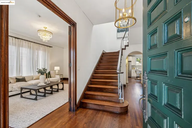 a view of entryway and hall with wooden floor