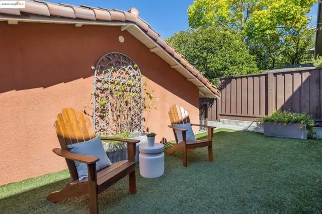 a view of a chairs and tables in the back yard of the house