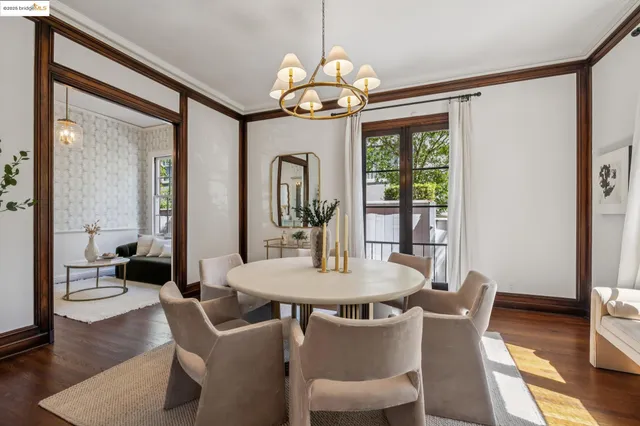 a dining room with furniture a chandelier and wooden floor