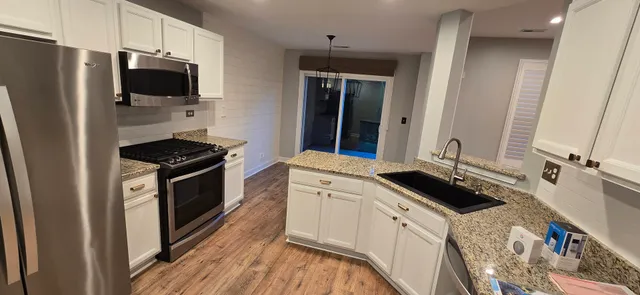 a kitchen with a sink stove and refrigerator