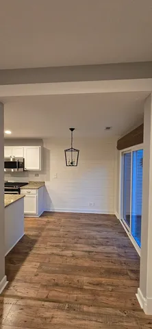 a view of a kitchen with microwave and cabinets