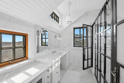 a bathroom with a sink a mirror and a shower