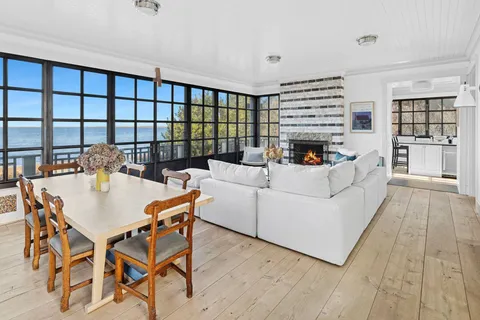 a living room with fireplace furniture and a floor to ceiling window