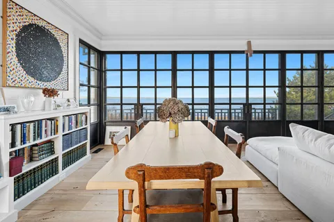a living room filled with furniture and a book shelf
