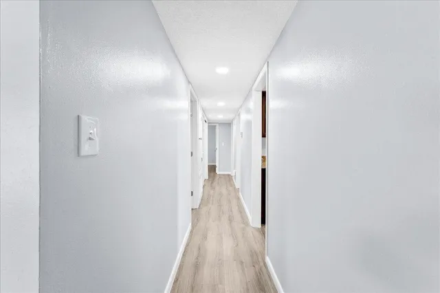 a view of hallway with wooden floor