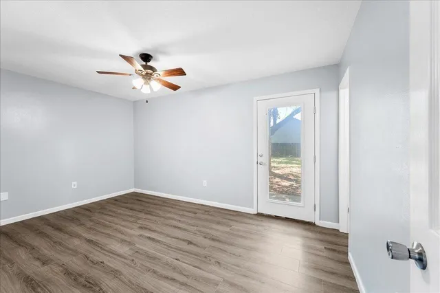 wooden floor in an empty room with a window