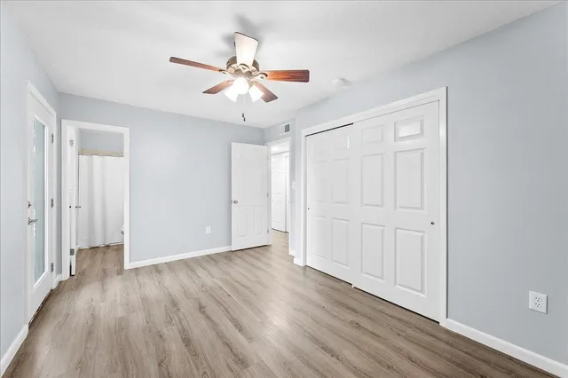 a view of an empty room with wooden floor
