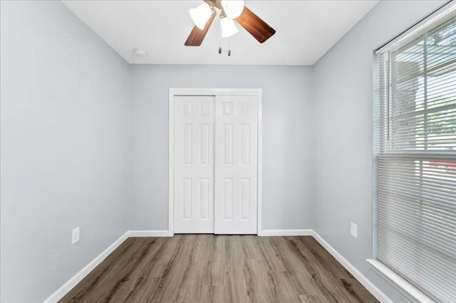 wooden floor in an empty room with a window