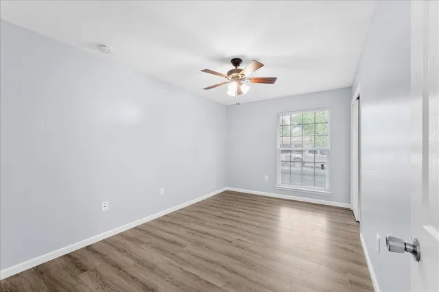 wooden floor in an empty room with a window