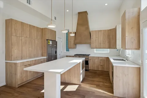 a kitchen with a sink a stove a refrigerator and a oven