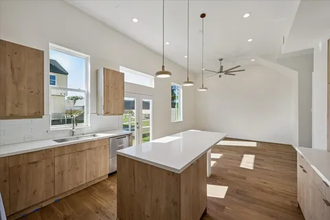a kitchen with a sink a counter space and wooden floor