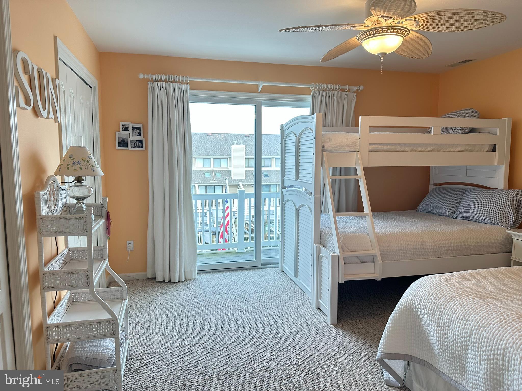 712 Mooring Road Ocean City, MD 21842 - Photo 16 of 60 a bedroom with a bed and a chandelier