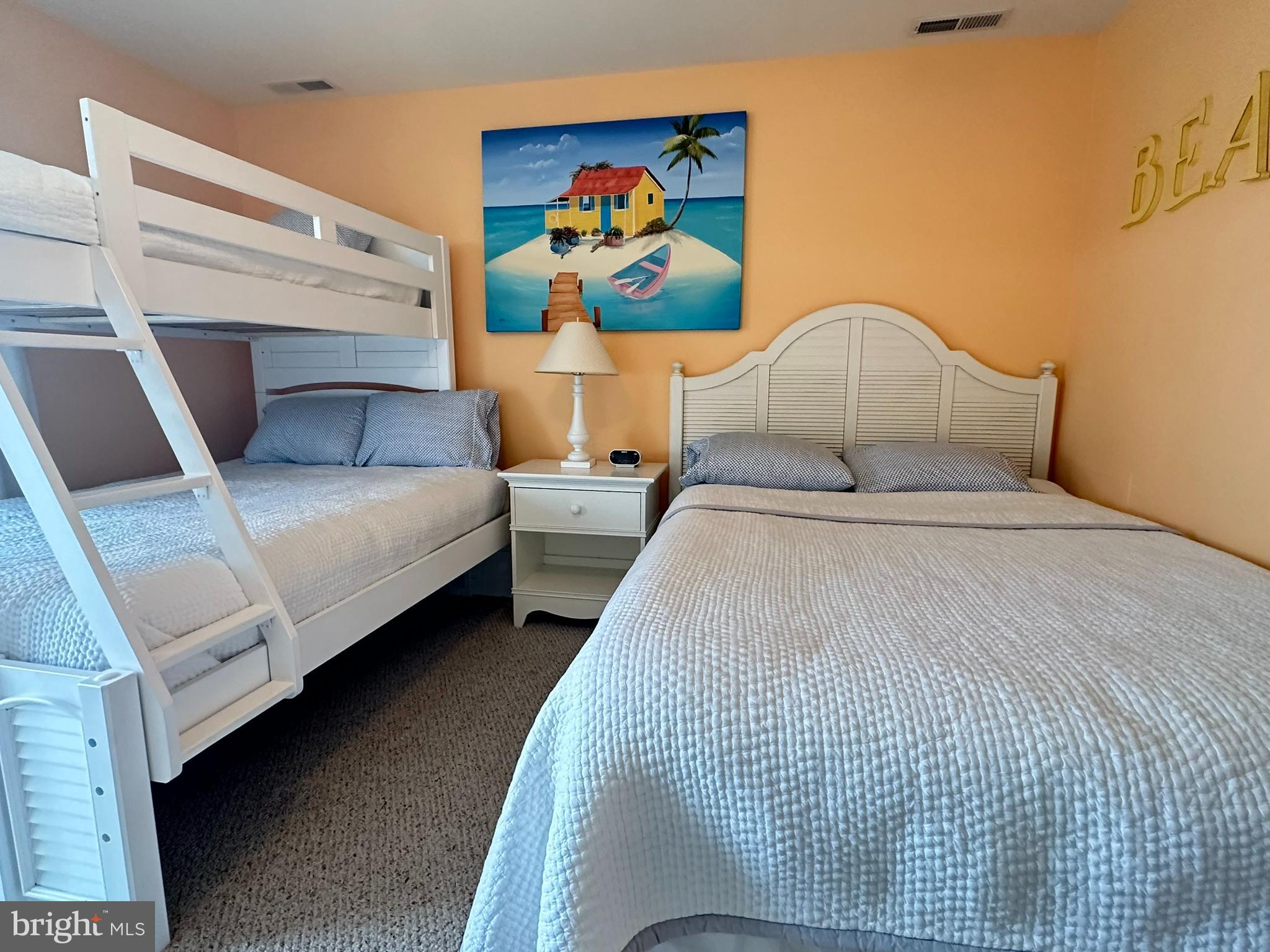 712 Mooring Road Ocean City, MD 21842 - Photo 18 of 60 a bedroom with bed and a couch