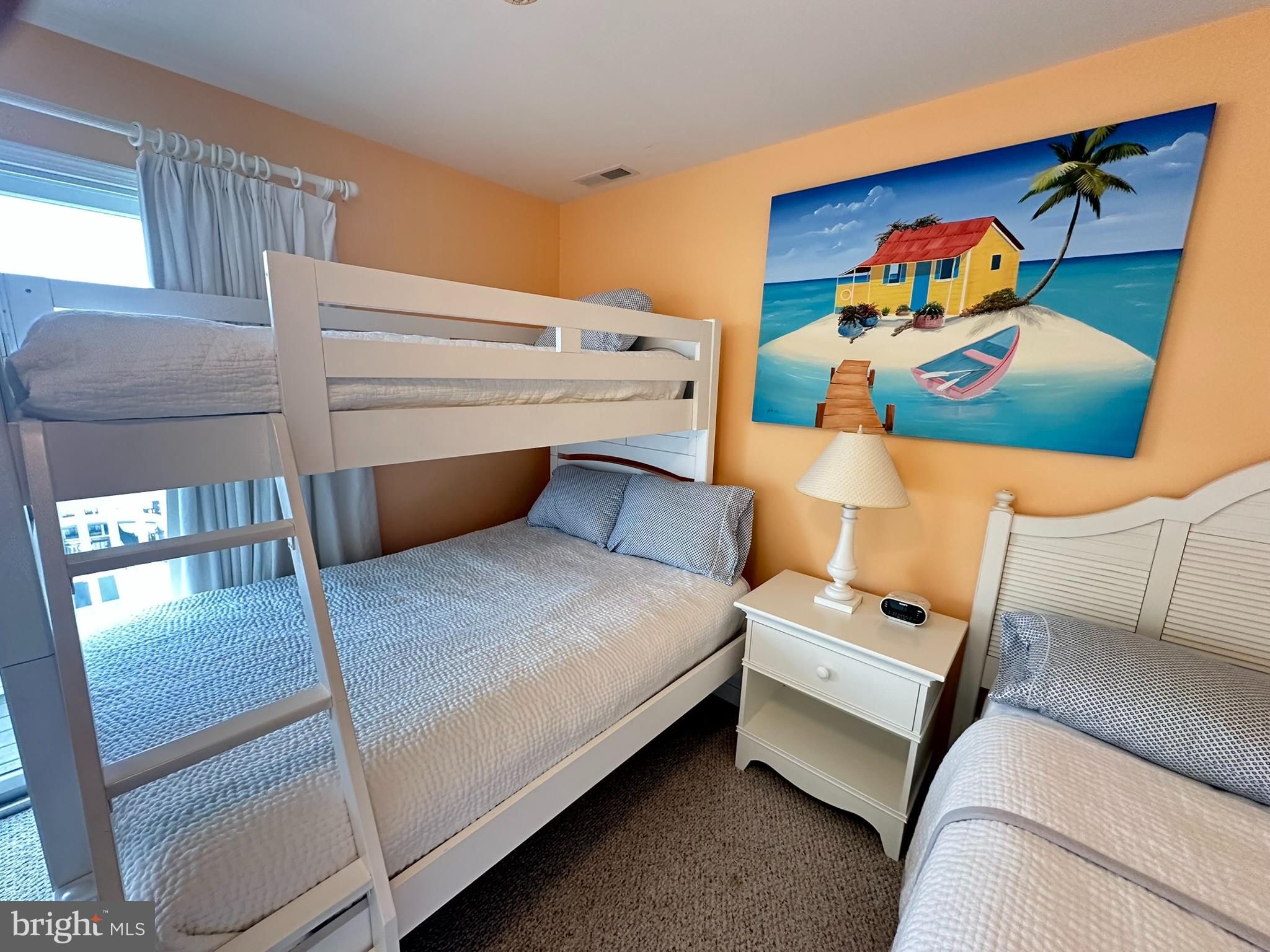 712 Mooring Road Ocean City, MD 21842 - Photo 19 of 60 a bed room with a bed and a painting on the wall