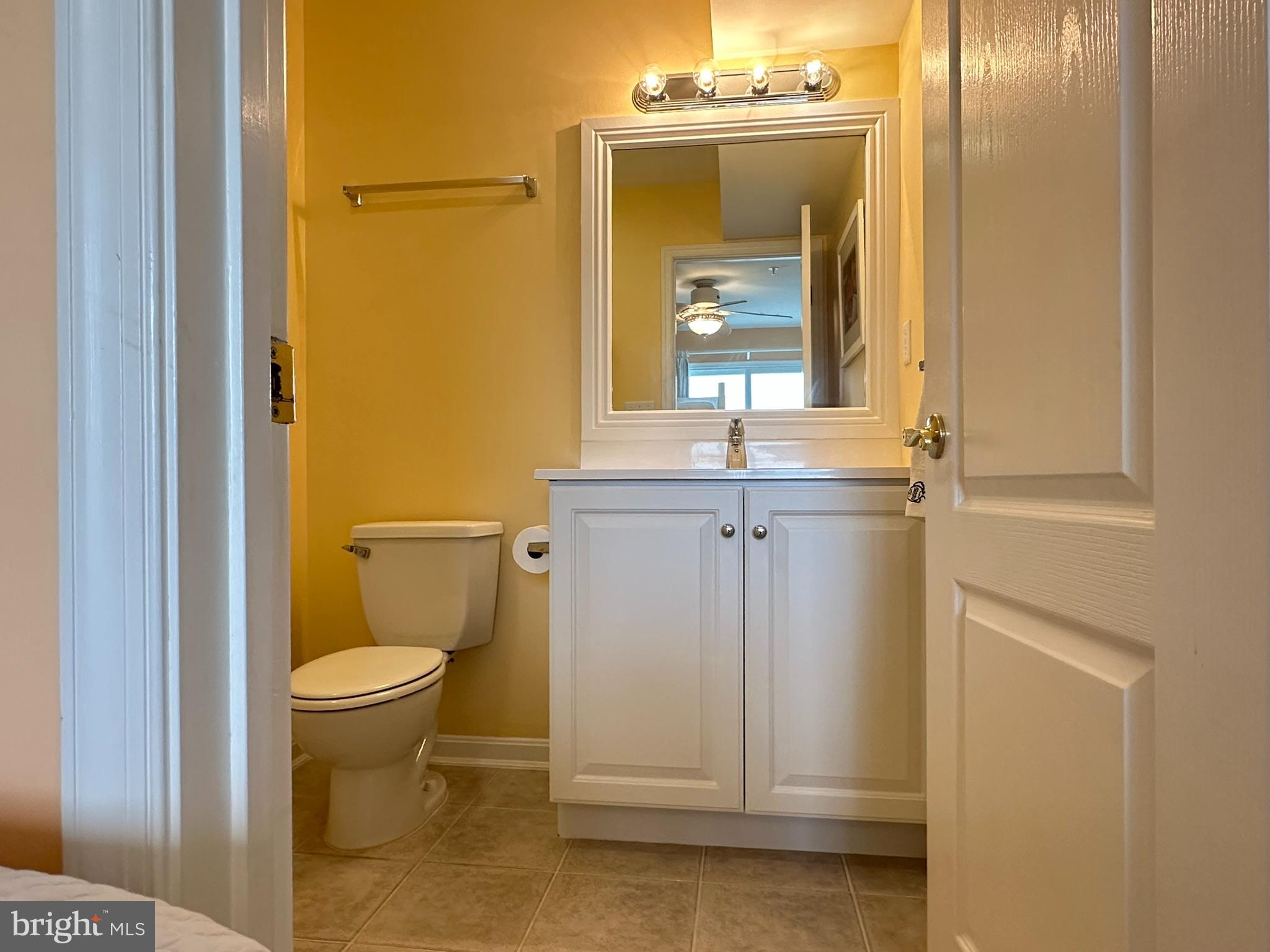 712 Mooring Road Ocean City, MD 21842 - Photo 21 of 60 a bathroom with a granite countertop sink toilet and mirror