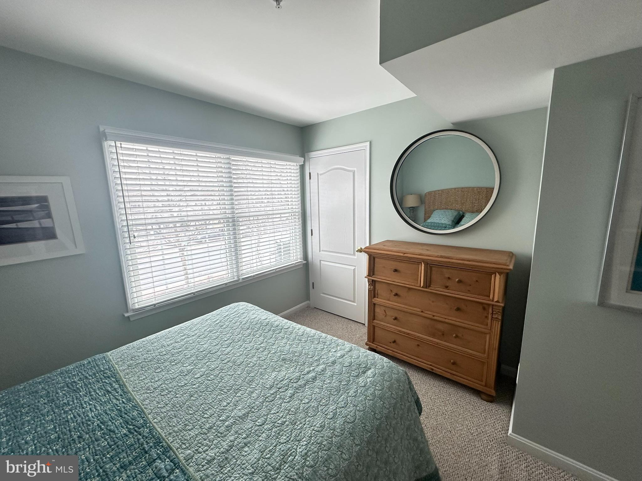 712 Mooring Road Ocean City, MD 21842 - Photo 27 of 60 a bedroom with a bed and a dresser
