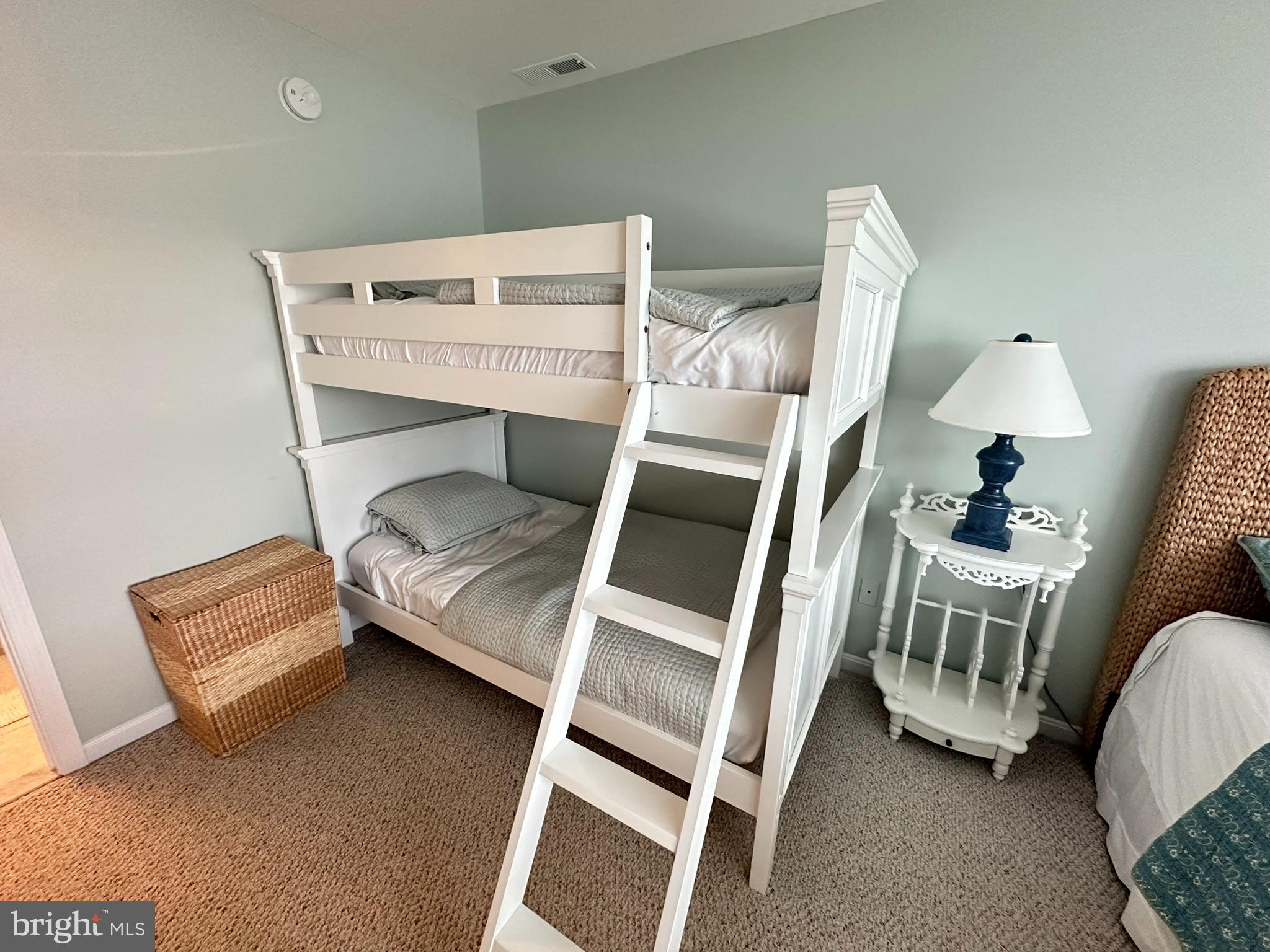 712 Mooring Road Ocean City, MD 21842 - Photo 31 of 60 a bedroom with a bed and a chair