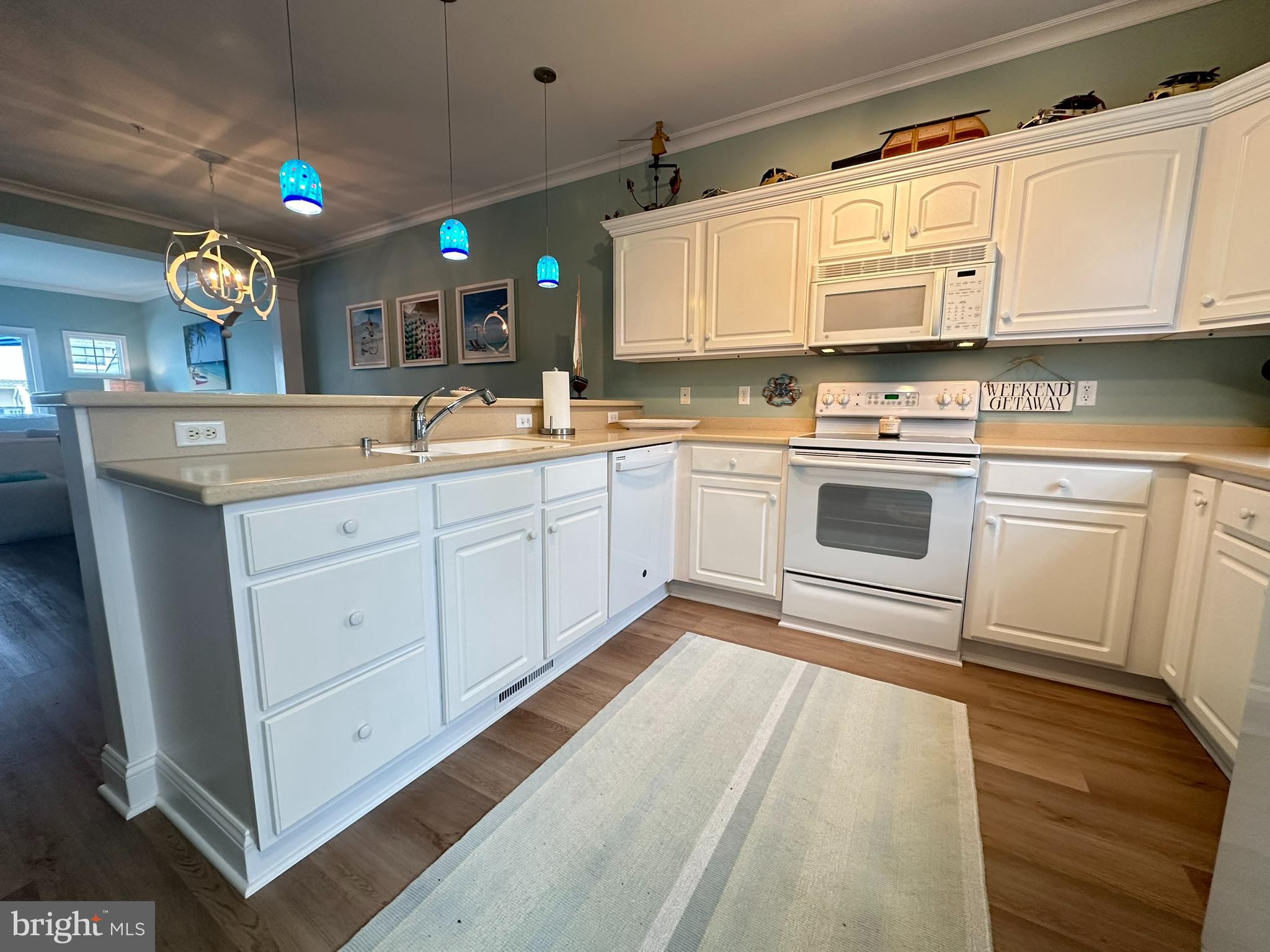 712 Mooring Road Ocean City, MD 21842 - Photo 4 of 60 a kitchen with granite countertop white cabinets and white appliances