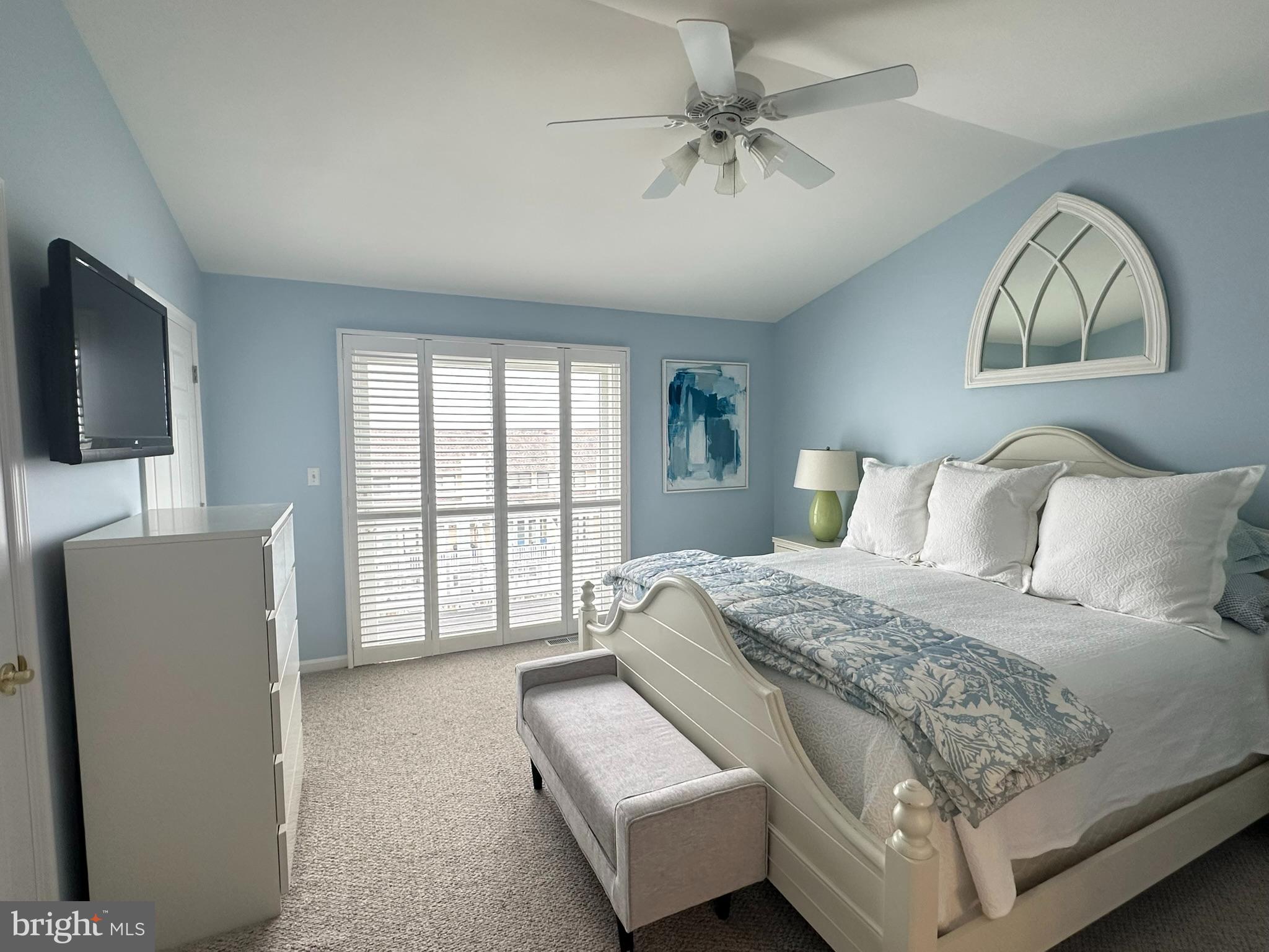 712 Mooring Road Ocean City, MD 21842 - Photo 41 of 60 a spacious bedroom with a bed and a flat screen television