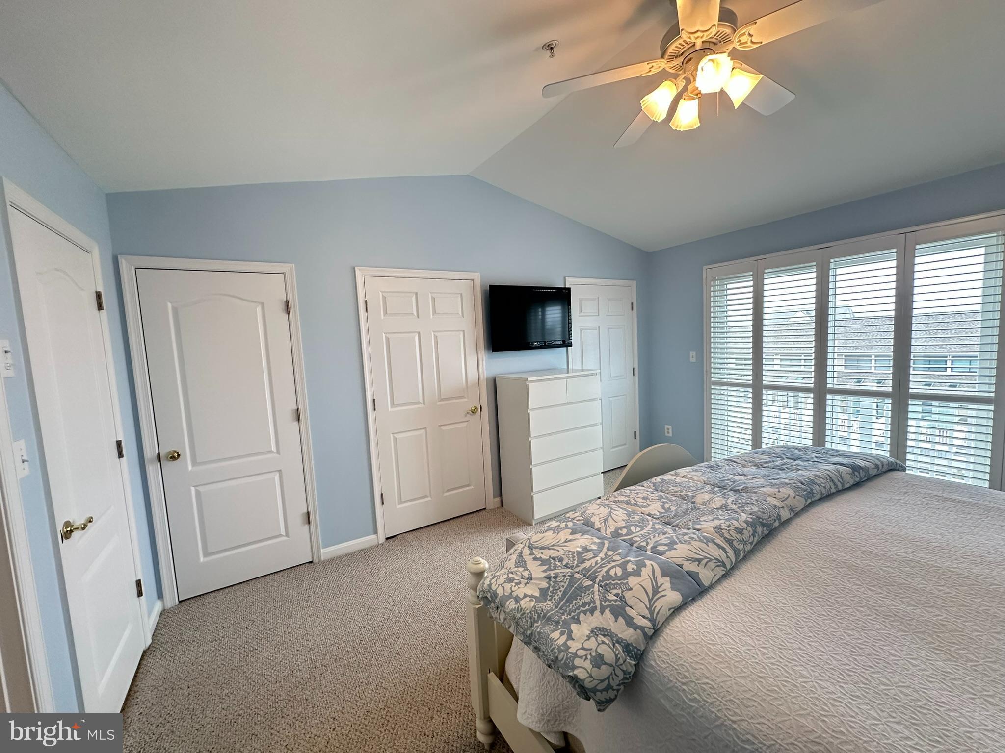712 Mooring Road Ocean City, MD 21842 - Photo 45 of 60 a bedroom with a large bed and a flat tv screen on dresser
