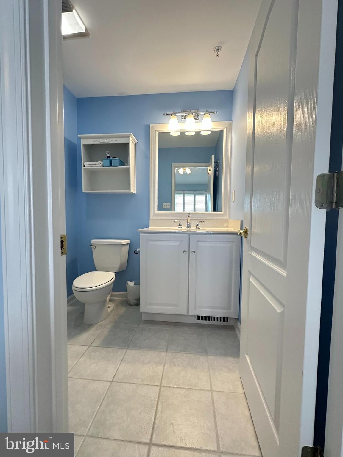 712 Mooring Road Ocean City, MD 21842 - Photo 47 of 60 a bathroom with a sink a toilet and mirror