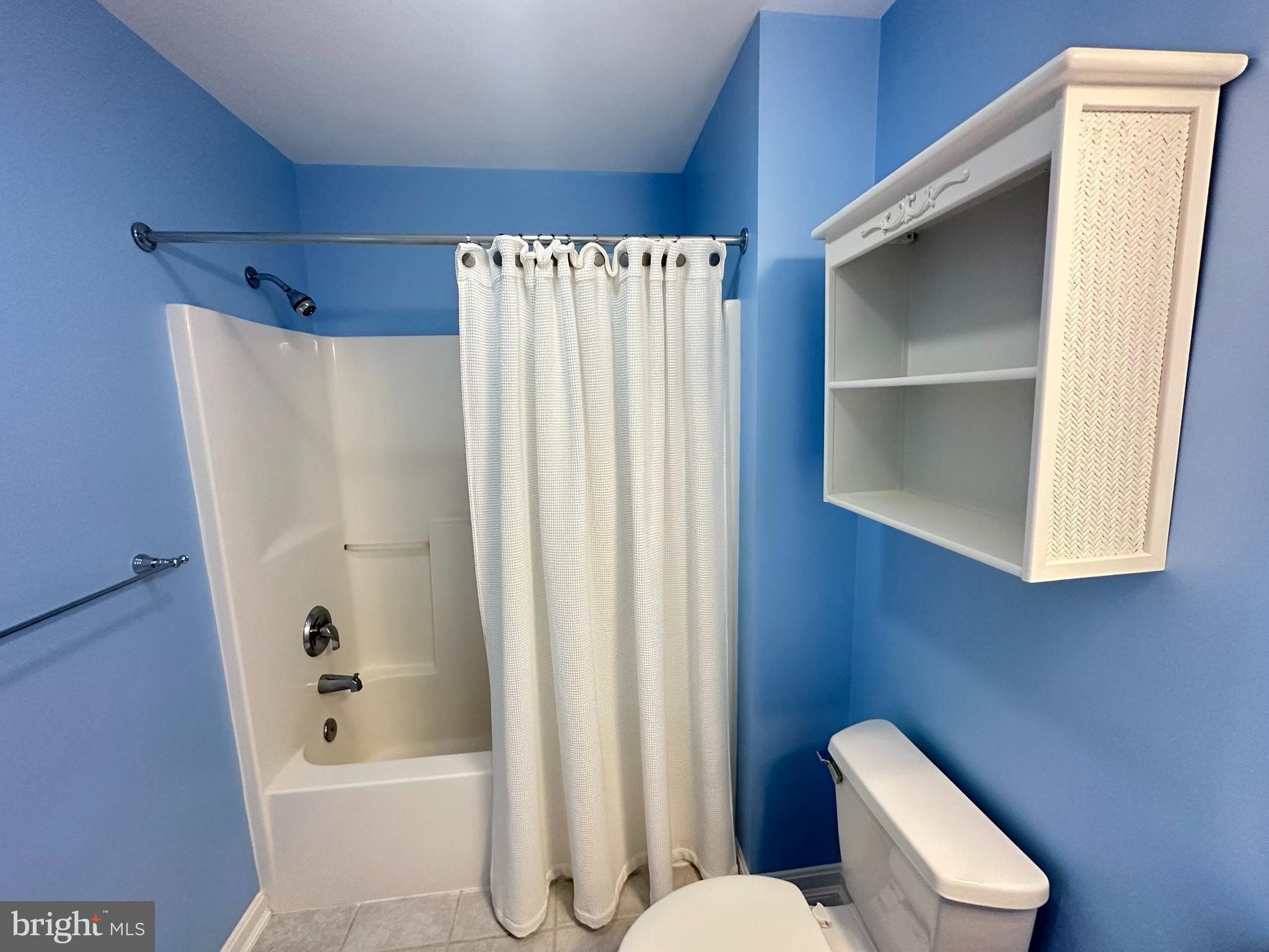 712 Mooring Road Ocean City, MD 21842 - Photo 48 of 60 a bathroom with a toilet and a shower curtain