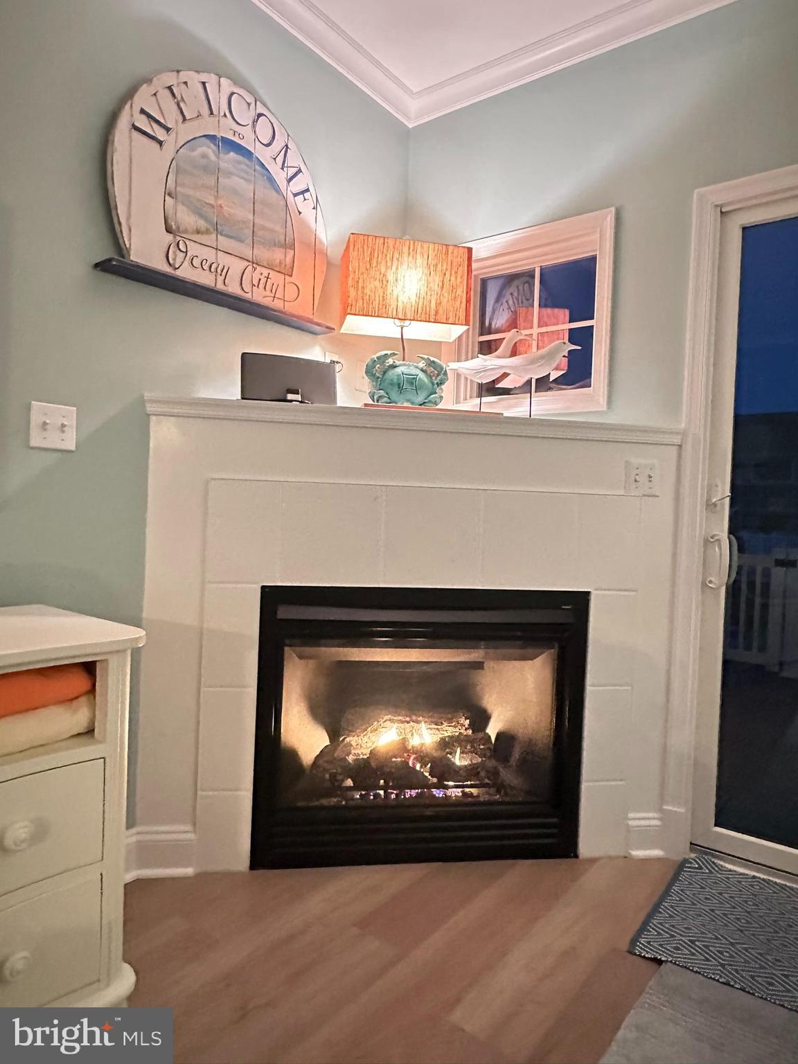 712 Mooring Road Ocean City, MD 21842 - Photo 54 of 60 a fireplace with a clock on wall