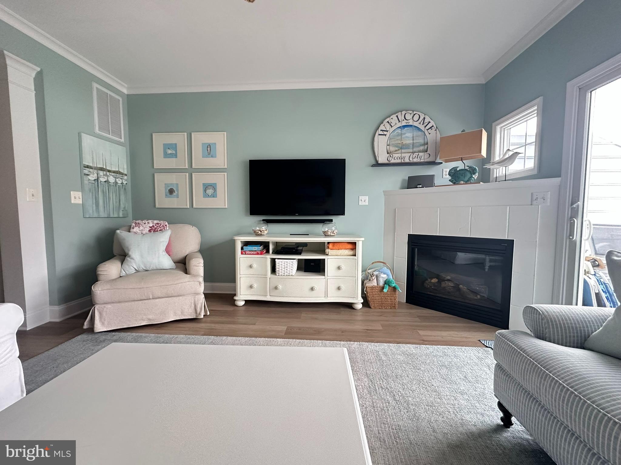 712 Mooring Road Ocean City, MD 21842 - Photo 10 of 60 a living room with furniture a flat screen tv and a fireplace