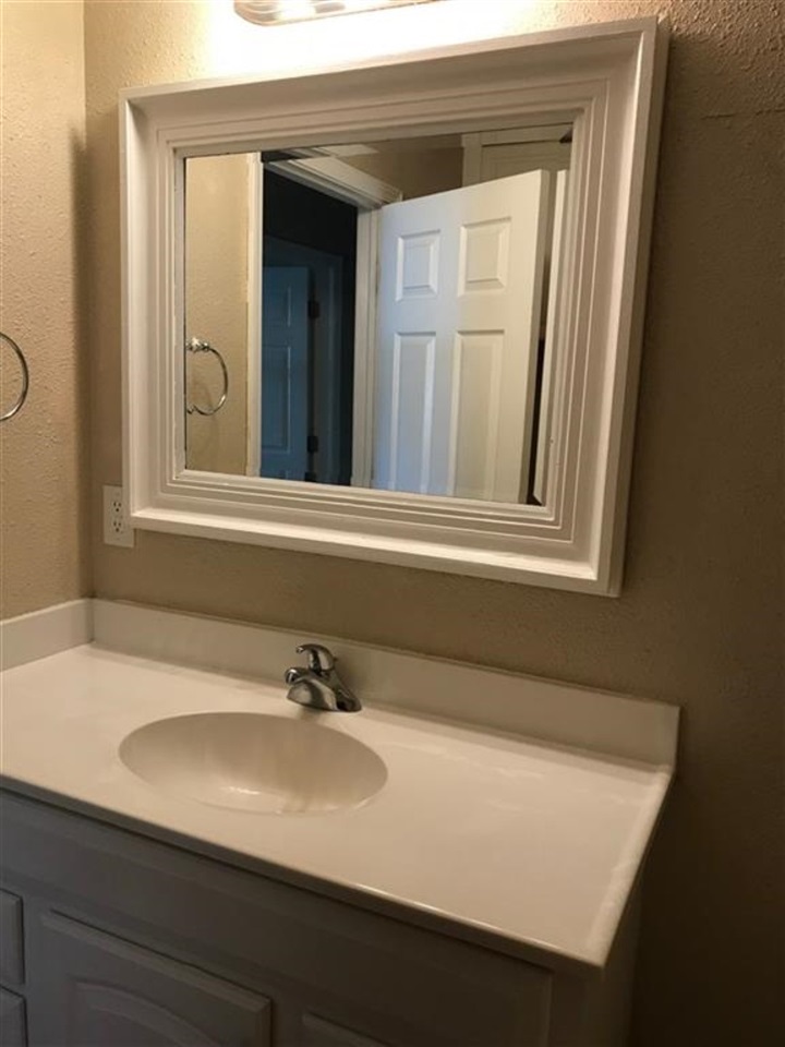 7606 Randy Road Machesney Park, IL 61115 - Photo 8 of 14 a bathroom with a sink and a mirror