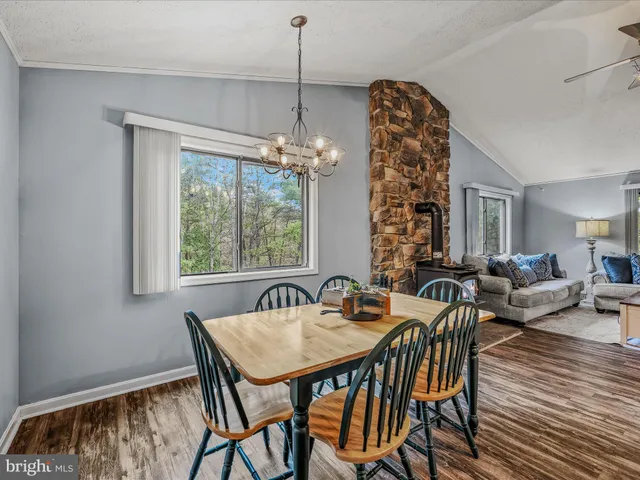 a view of a dining room with furniture and chandelier