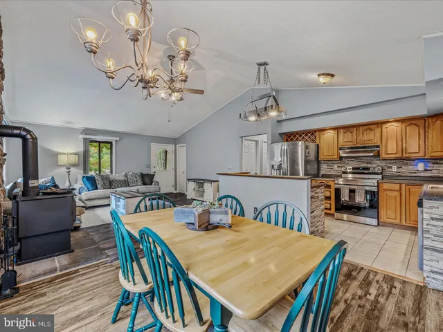 a view of a dining room with furniture a chandelier and wooden floor