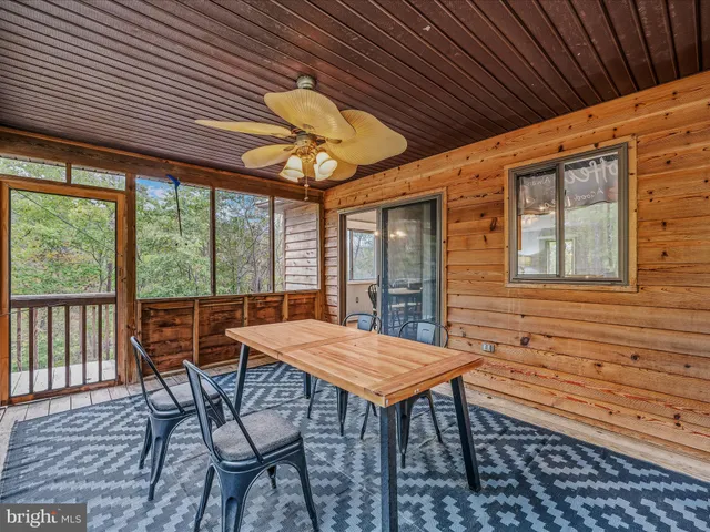 a view of a patio with table and chairs