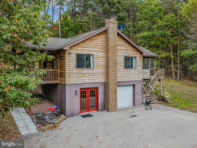 a view of a house with a yard and garage
