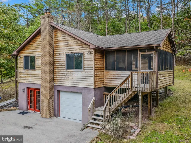 a view of a house with a small deck and a wooden floor