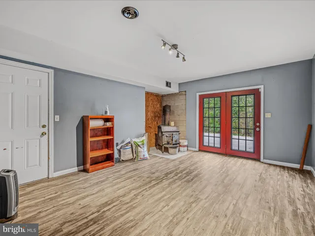 a view of a bedroom with furniture window and a ceiling fan