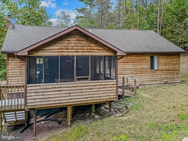 a view of a house with a yard and wooden floor