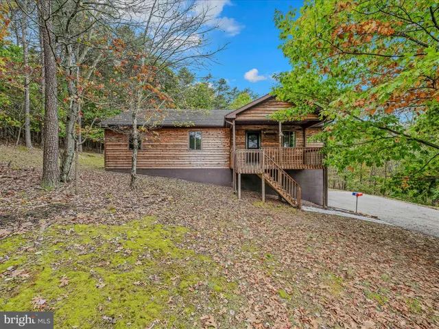 a view of a small house with a yard